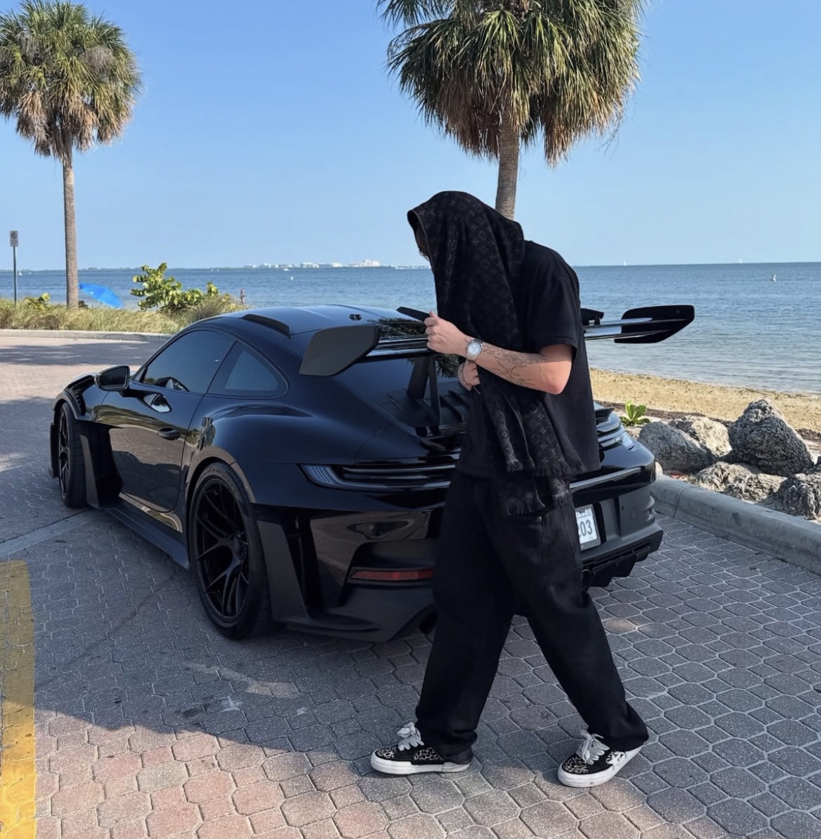Fareed — black Porsche GT3 RS, waterfront, all-black fit